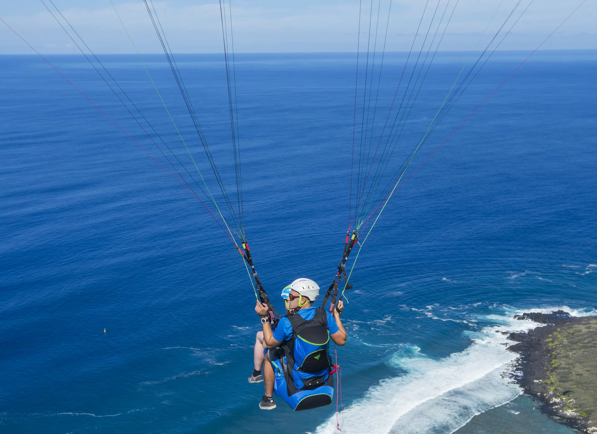 Vol parapente biplace à La Réunion – École et baptême – VolParapente.fr Vol parapente biplace au-dessus du littoral de La Réunion, entre mer et nuages, avec une école de parapente locale.